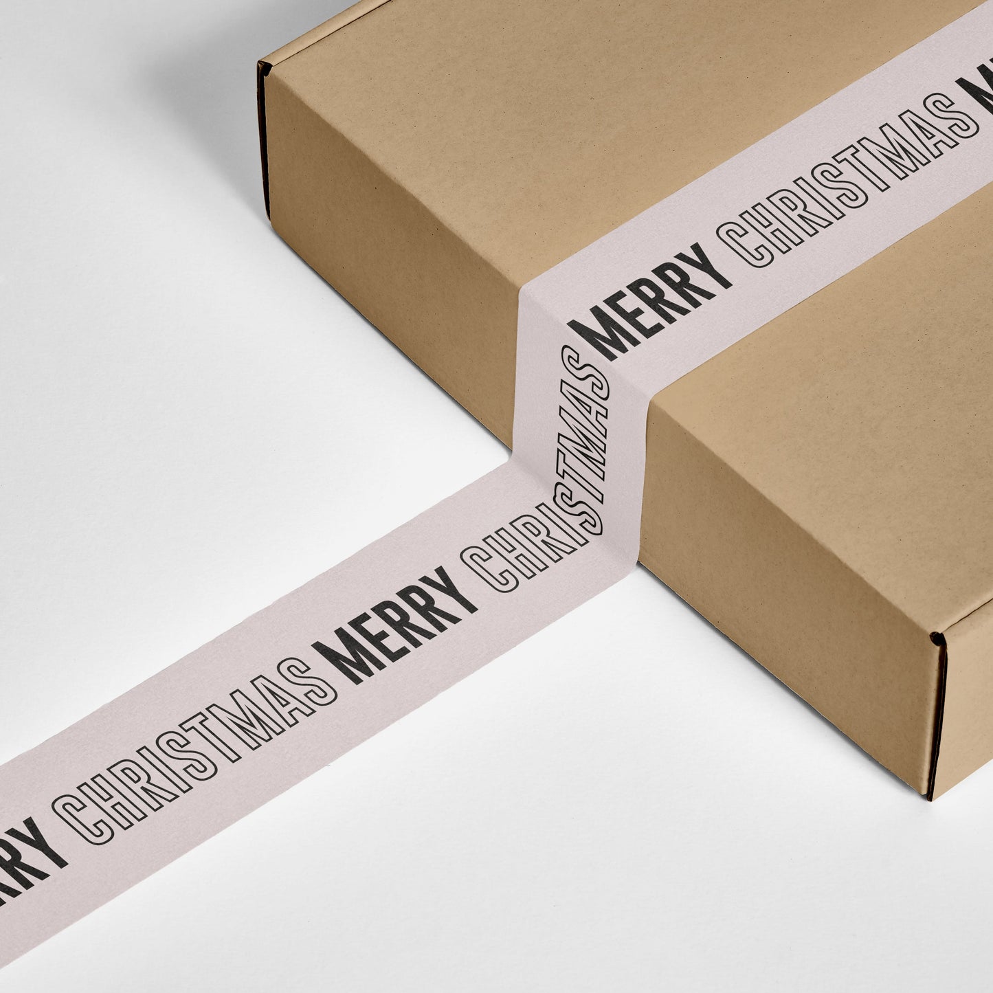 Parcel sealed with Merry Christmas printed tape, ready for festive shipping.