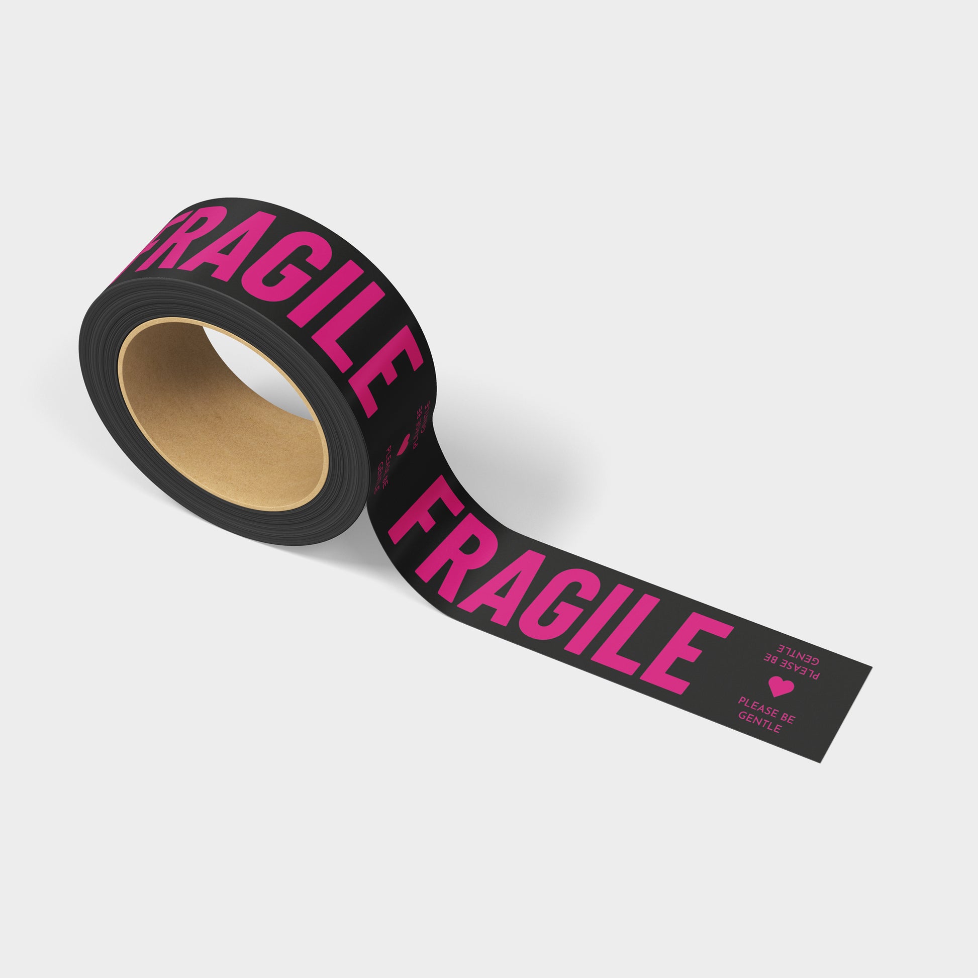 A roll of printed shipping tape with the words Fragile Please Be Gentle in hot pink colors and black tape.