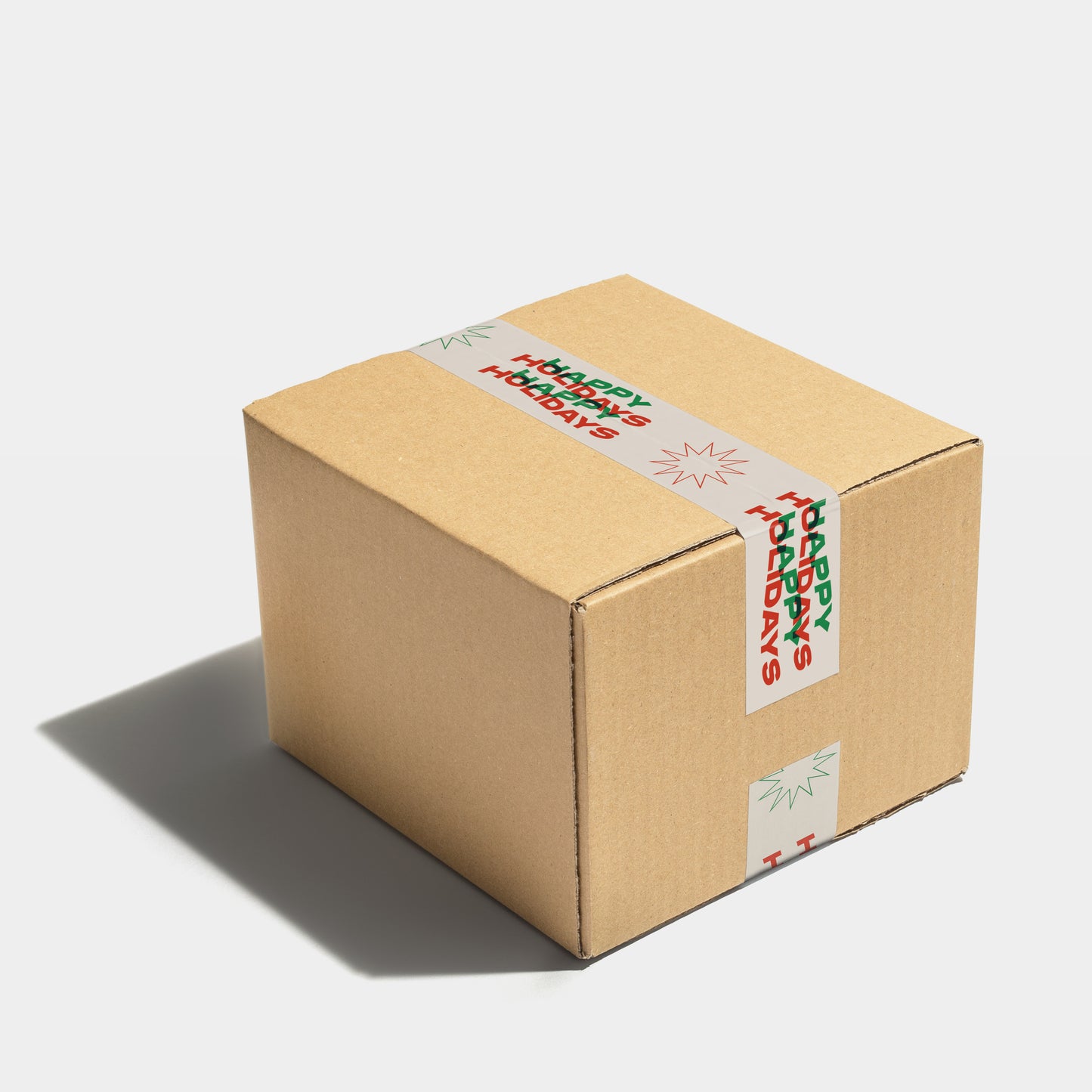 A shipping parcel wrapped in shipping tape with colorful printed wavy text in bold font that reads "happy holidays".