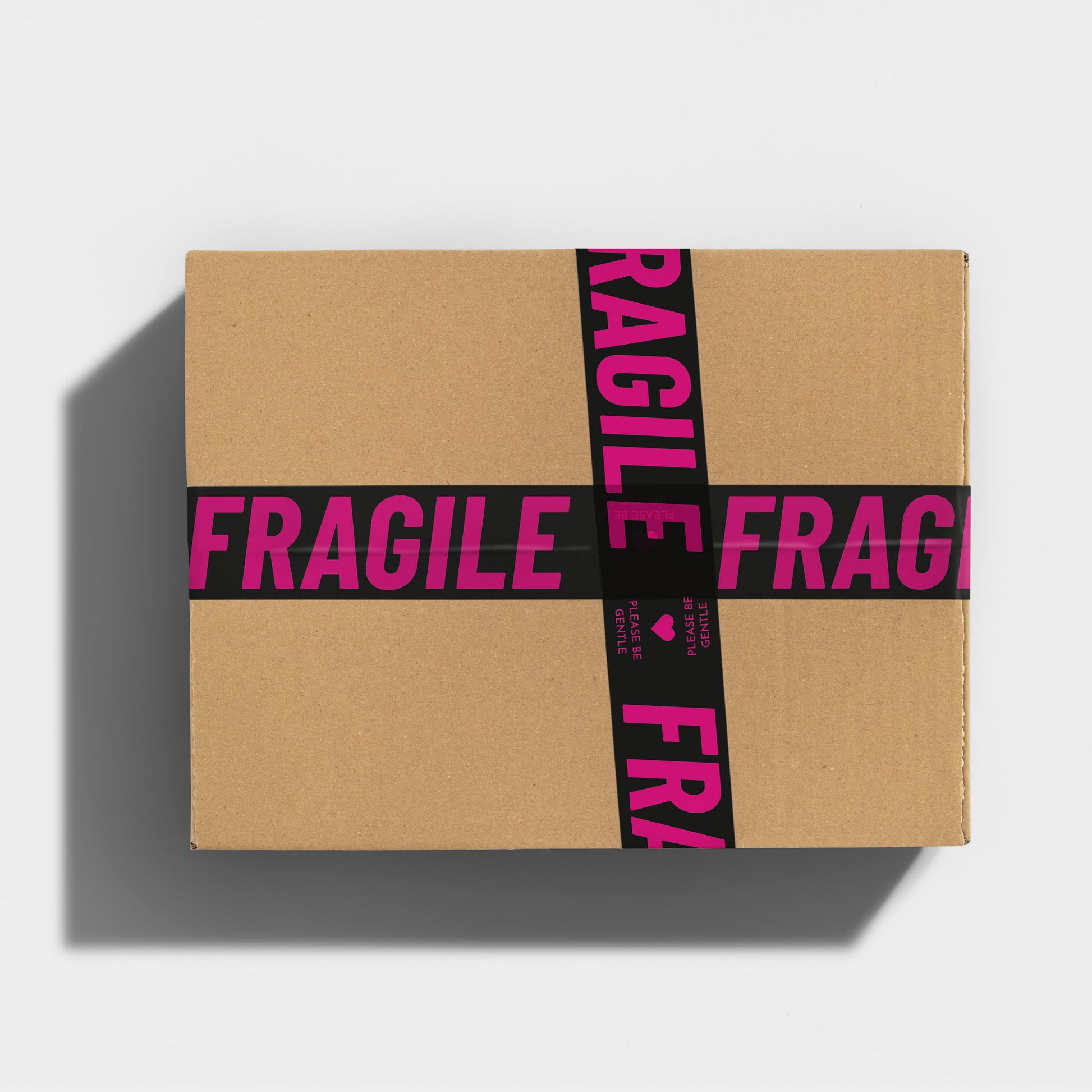 A gift box wrapped in fun Fragile printed packing tape.