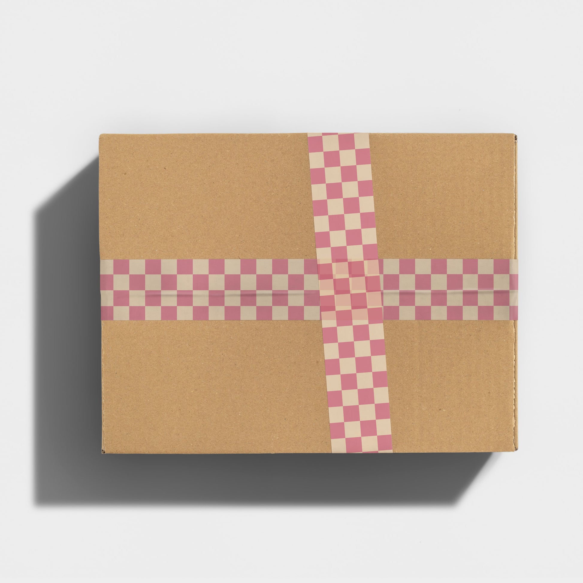 A package sealed with checkered printed shipping tape.