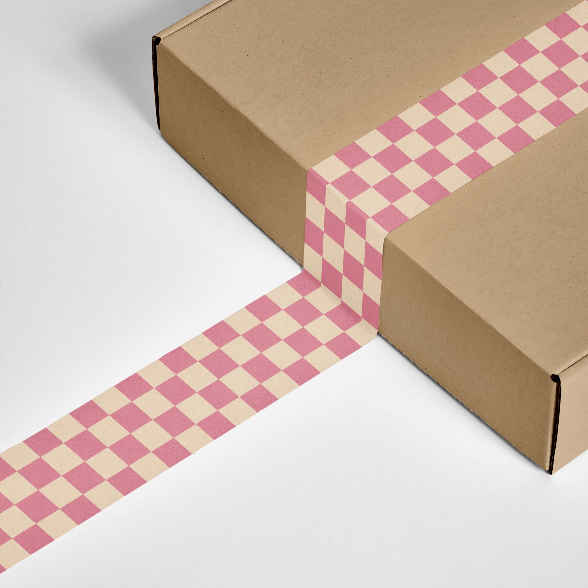 A box sealed with checkered printed shipping tape.