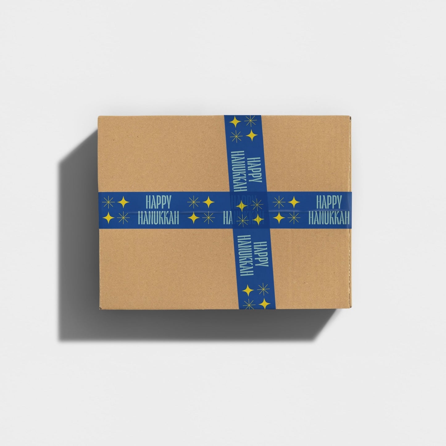 Holiday gift parcel decorated with 'Happy Hanukkah' message in vibrant blue and yellow tape.