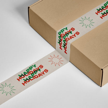 A gift box secured with Happy Holidays Shippy Tape in red and green holiday colors.